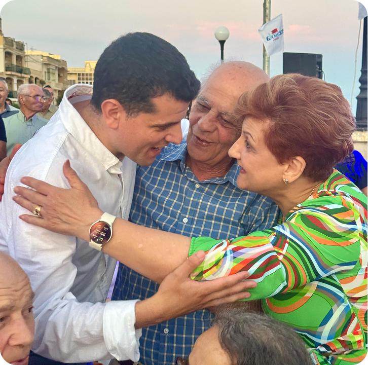 Beppe embracing community members
